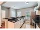 Modern kitchen with stainless steel appliances, granite countertops, and white cabinets at 1331 Memorial Se Dr, Atlanta, GA 30317
