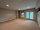 Basement featuring carpet, natural lighting, and door to the exterior at 1595 Chadberry Way, Lawrenceville, GA 30043