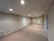Finished basement features carpeted floors, recessed lighting, and white doors at 1595 Chadberry Way, Lawrenceville, GA 30043