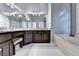 Bathroom features a granite countertop vanity with white tile floors and garden tub at 1595 Chadberry Way, Lawrenceville, GA 30043