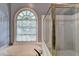 Relaxing bathroom with a large window over tub and glass enclosed shower at 1595 Chadberry Way, Lawrenceville, GA 30043