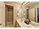 Bathroom features a white vanity with double sinks and shower-tub combo at 1595 Chadberry Way, Lawrenceville, GA 30043