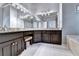 Bathroom features a granite countertop vanity with white tile floors and garden tub at 1595 Chadberry Way, Lawrenceville, GA 30043