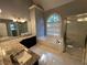 Luxurious bathroom featuring granite countertops, tub, and walk-in shower at 1595 Chadberry Way, Lawrenceville, GA 30043