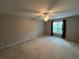 Bedroom offers neutral carpet and walls, large window, and ceiling fan at 1595 Chadberry Way, Lawrenceville, GA 30043