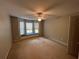 Spacious bedroom features neutral walls, carpet, ceiling fan, and window seat at 1595 Chadberry Way, Lawrenceville, GA 30043