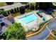 Aerial view of the community pool showing ample seating, umbrellas, and a gated entrance at 1595 Chadberry Way, Lawrenceville, GA 30043
