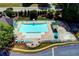 Aerial view of the community pool showing ample seating, umbrellas, and a gated entrance at 1595 Chadberry Way, Lawrenceville, GA 30043