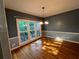 Dining room with hardwood floors, chair rail, and large window with views at 1595 Chadberry Way, Lawrenceville, GA 30043
