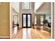 Grand foyer featuring hardwood floors and stylish decorative wrought iron double doors at 1595 Chadberry Way, Lawrenceville, GA 30043