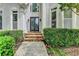 Elegant front entrance with stone steps and decorative glass doors at 1595 Chadberry Way, Lawrenceville, GA 30043