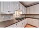 Close-up of a kitchen with white cabinets, granite countertops, and gas cooktop at 1595 Chadberry Way, Lawrenceville, GA 30043
