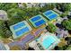 Aerial view of community amenities include pool, tennis courts, and a parking lot at 1595 Chadberry Way, Lawrenceville, GA 30043