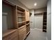 Walk-in closet with custom shelves, drawers and clothing racks at 1595 Chadberry Way, Lawrenceville, GA 30043