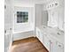 Bathroom featuring double sinks, tub and shower, and wood floors at 3968 Oak Glenn Dr, Duluth, GA 30096
