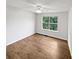 Sunny bedroom featuring hardwood floors and a large window with tree view at 3968 Oak Glenn Dr, Duluth, GA 30096