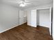 Neutral bedroom featuring hardwood floors and closet at 3968 Oak Glenn Dr, Duluth, GA 30096