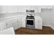 Efficient, all white kitchen features updated appliances and countertops at 3968 Oak Glenn Dr, Duluth, GA 30096