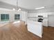 Spacious living area with hardwood floors, white cabinets, and stainless steel appliances at 3968 Oak Glenn Dr, Duluth, GA 30096