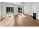 Bright living room with patio access, fireplace, and modern wood flooring at 3968 Oak Glenn Dr, Duluth, GA 30096
