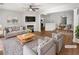 Bright, open living room with fireplace, modern decor, and access to dining area at 3968 Oak Glenn Dr, Duluth, GA 30096