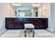 Bathroom featuring dual vanity with dark wood cabinets and a large mirror at 724 Laura Jean Ct, Buford, GA 30518