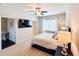 Bedroom with TV, bedside table with lamp, and window with blinds at 724 Laura Jean Ct, Buford, GA 30518