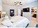 Bedroom featuring a ceiling fan, TV, and bathroom access at 724 Laura Jean Ct, Buford, GA 30518