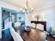 Elegant dining room with dark wood floors and a stylish chandelier at 724 Laura Jean Ct, Buford, GA 30518