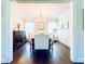 Elegant dining room featuring a chandelier, wainscoting, and dark hardwood flooring at 724 Laura Jean Ct, Buford, GA 30518