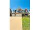 Charming two-story home featuring brick accents, a three-car garage, and a beautifully landscaped front yard at 724 Laura Jean Ct, Buford, GA 30518