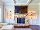 Living room fireplace has a stone surround and custom built-in shelving at 724 Laura Jean Ct, Buford, GA 30518