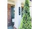 Close-up of the front porch featuring a column, house number, and an evergreen shrub at 724 Laura Jean Ct, Buford, GA 30518