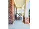 Inviting front porch with comfortable seating, classic brick detailing, and a bright, welcoming ambiance at 724 Laura Jean Ct, Buford, GA 30518