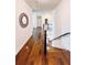 Hardwood hallway with staircase and decorative mirror at 724 Laura Jean Ct, Buford, GA 30518