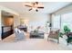 Cozy living room with comfortable seating, neutral decor, and a ceiling fan at 724 Laura Jean Ct, Buford, GA 30518