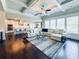Open-concept living room with hardwood floors and bright windows at 724 Laura Jean Ct, Buford, GA 30518