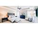 Carpeted main bedroom featuring tray ceilings, a tufted headboard, and large windows at 724 Laura Jean Ct, Buford, GA 30518