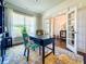 Bright office space with French doors, stylish rug, a large window, and built-in bookcases at 724 Laura Jean Ct, Buford, GA 30518