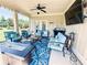 Inviting covered patio featuring comfortable seating, a ceiling fan, and an outdoor TV at 724 Laura Jean Ct, Buford, GA 30518