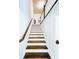 Staircase features hardwood treads, white risers, and a dark wood handrail at 724 Laura Jean Ct, Buford, GA 30518