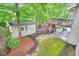 Overhead view of a verdant backyard with a storage shed, deck, stone pathway, and mature trees at 1206 Mountainside Nw Trce, Kennesaw, GA 30152