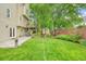Expansive backyard featuring a lush lawn, mature trees, patio, and charming landscaping at 1206 Mountainside Nw Trce, Kennesaw, GA 30152