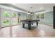 Finished basement featuring tile flooring, a pool table illuminated by stylish pendant lights, and French doors to outside at 1206 Mountainside Nw Trce, Kennesaw, GA 30152