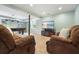 Finished basement area with tile flooring, pool table, television and two comfortable brown reclining chairs at 1206 Mountainside Nw Trce, Kennesaw, GA 30152
