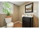 Cozy bathroom featuring a black vanity and a window with natural light at 1206 Mountainside Nw Trce, Kennesaw, GA 30152