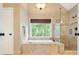 Bathroom featuring a soaking tub, tiled shower, and window with natural light at 1206 Mountainside Nw Trce, Kennesaw, GA 30152
