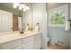Bathroom featuring a white vanity, large mirror, and a window providing natural light at 1206 Mountainside Nw Trce, Kennesaw, GA 30152