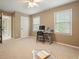 Neutral bedroom featuring natural light from two windows and desk with computer setup at 1206 Mountainside Nw Trce, Kennesaw, GA 30152