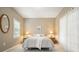 Cozy bedroom with neutral tones, soft lighting, and a large window with blinds at 1206 Mountainside Nw Trce, Kennesaw, GA 30152